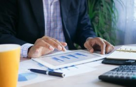 Mand ved bord kigger på grafer.