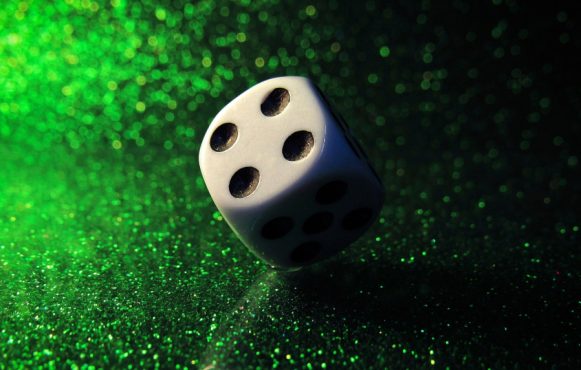 Terning med grøn glimmer baggrund.