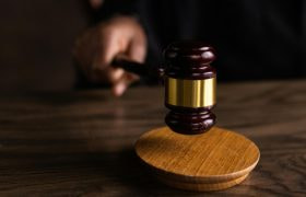 Houten rechter hamer in handen van rechter