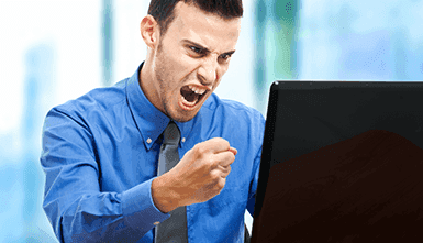 An angry and distraught player sitting at a computer.
