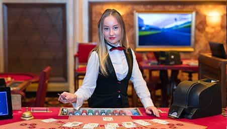 A smiling croupier at a Diners Club casino.