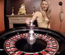 A LeoVegas live dealer at a roulette wheel.