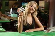 A cheerful blackjack dealer at a live casino.