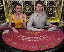 A live dealer dealing a blackjack game.