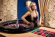 A professional roulette croupier at a live casino.
