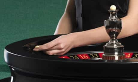 a hand throwing a roulette ball into the wheel