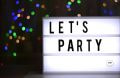 Imagine cu fon negru si text “Lets Party”