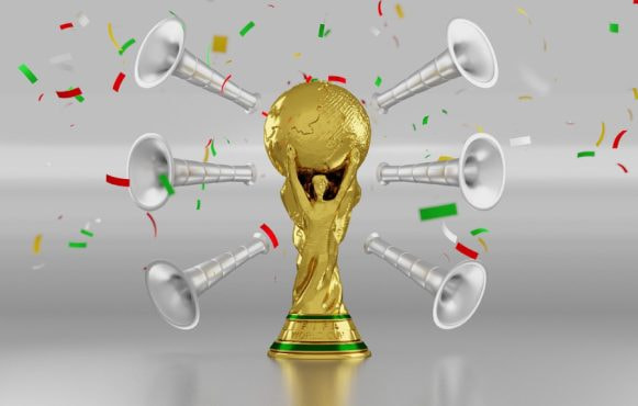 Trofeu de aur înconjurat de vuvuzele, simbolizând celebrarea unei victorii importante.