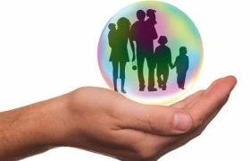 An open hand holding an orb containing the silhouette of a family.