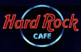 The highly recognizable and world-famous Hard Rock Café sign in red and blue neon lettering.