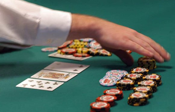 A dealer counts out chips during a hand of Texas Hold’em.