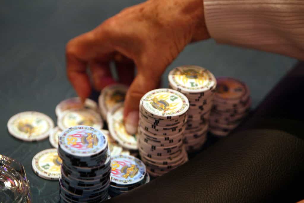 A pile of unstacked chips at a poker table.