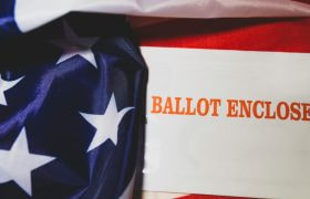 An enclosed ballot with the US flag