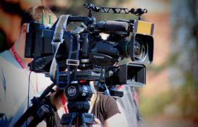 A person holding a big camera