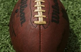 Football positioned on green field