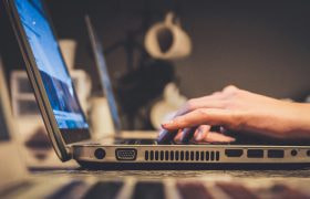 Person inputting information on a laptop computer