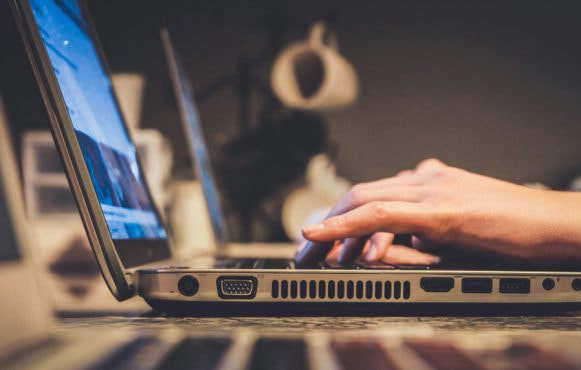 Person inputting information on a laptop computer