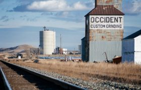Grain Silos along railroad track in small town