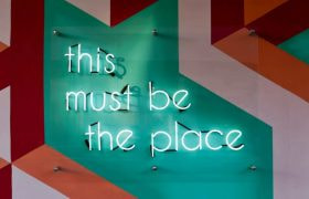 A sign saying 'This must be the place'