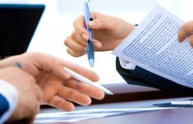 People in a meeting with documents