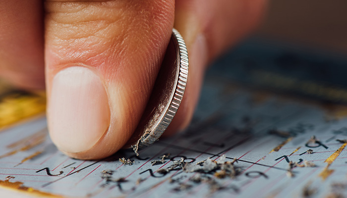 Person playing scratch card