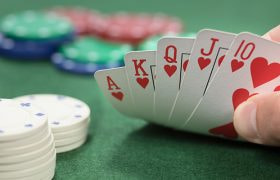 straight-flush-hand-of-a-poker-player-at-a-physical-casino_