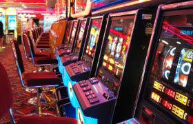 Long row of slot machines waiting to be played.