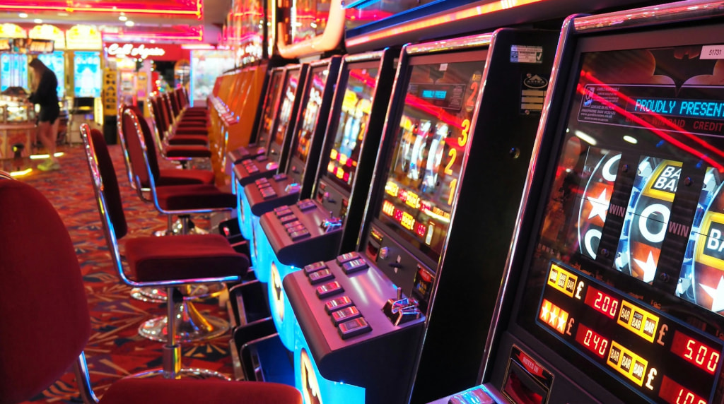 Long row of slot machines waiting to be played.