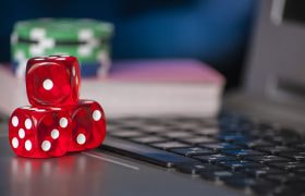 Poker chips and dice on a laptop
