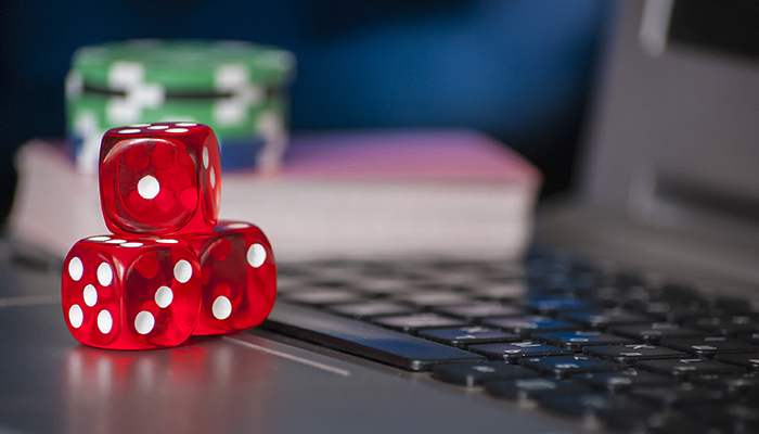Poker chips and dice on a laptop