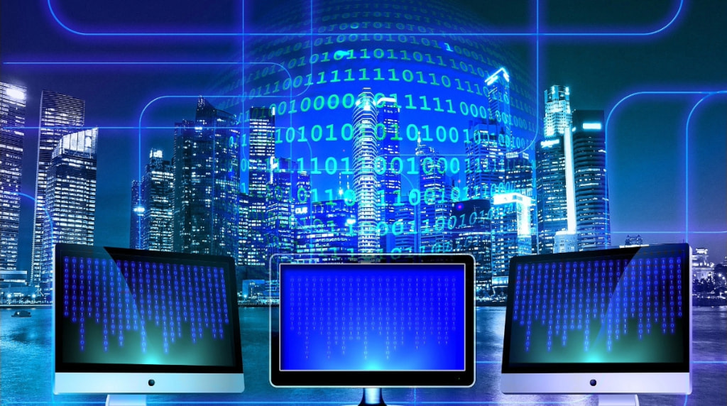 Computer monitors in front of city sape as information flows.