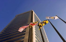 Flags flutter outside a building in Baltimore, Maryland Harbor
