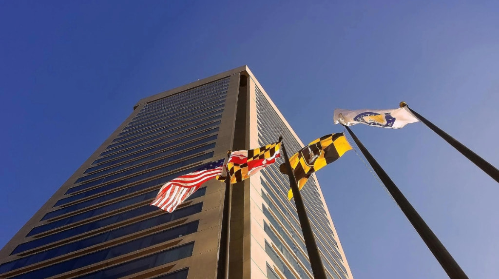 Flags flutter outside a building in Baltimore, Maryland Harbor