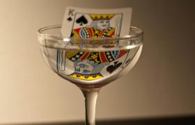 A king playing card in a wine glass
