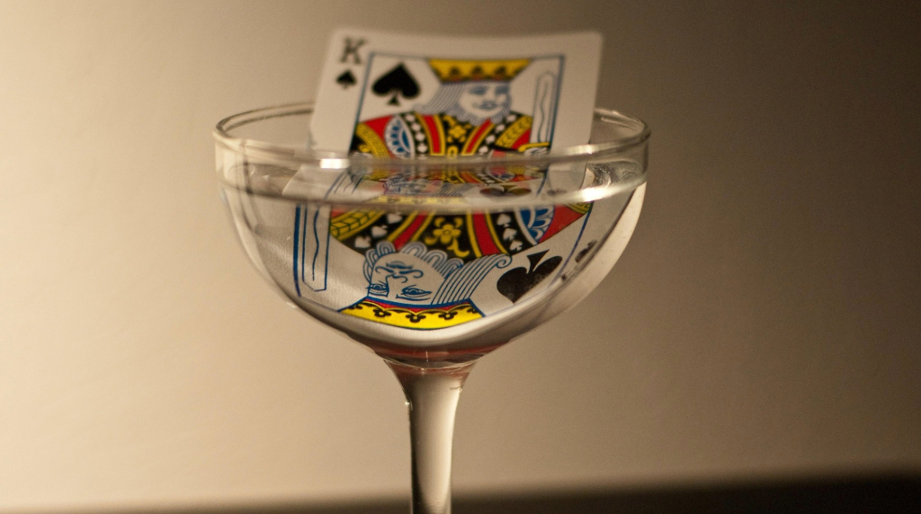 A king playing card in a wine glass