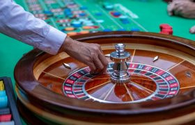 Dealer spinning ball on roulette