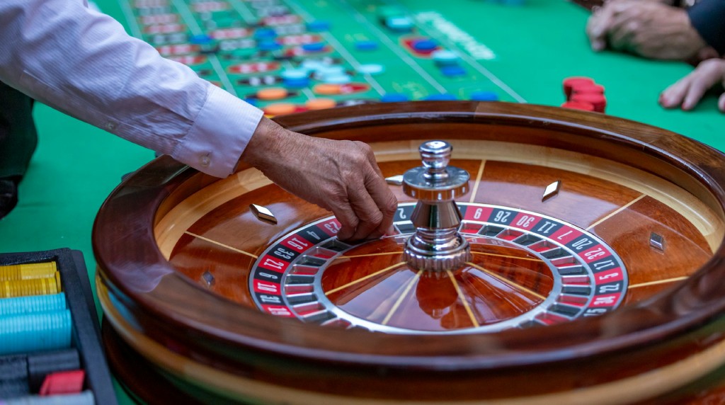Dealer spinning ball on roulette