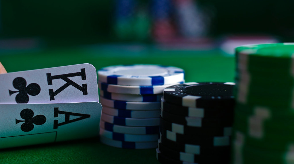 The player's Ace King behind a stack of checks.
