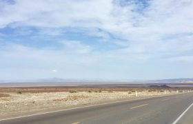 Nevada's empty desert under bright blue sky.