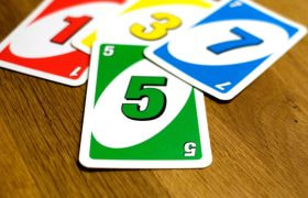 Uno Cards strewn across a wooden table