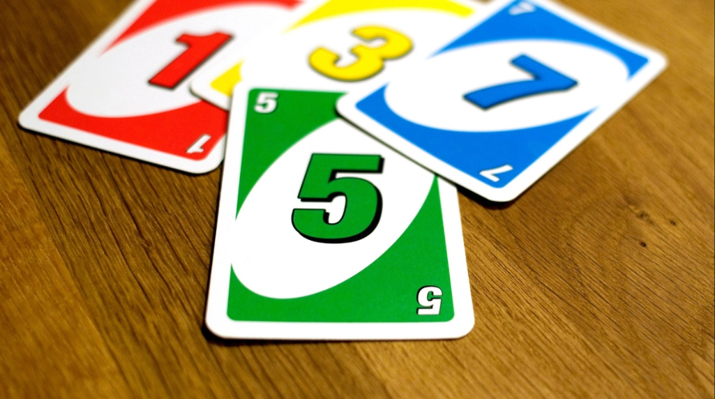 Uno Cards strewn across a wooden table