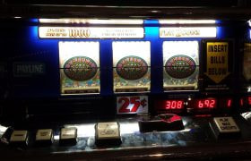 Slot machine with jackpot showing on reels.