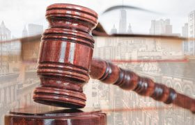 Judge's gavel against a city skyline
