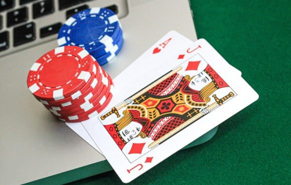 Laptop with casino cards and chips