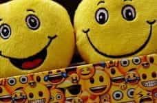 An image of two Emoji cushions in an emoji-themed box.