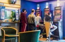 An image of UK gamblers playing at FOBTs in a bookmakers shop