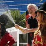 Branson celebrates with champagne at the announcement of the acquisition in Las Vegas.