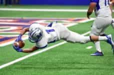 American footballer leaping for the goal line.