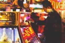 A man using a slot machine.