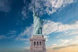 The Statue of Liberty in New York in front of a cloudy sky.